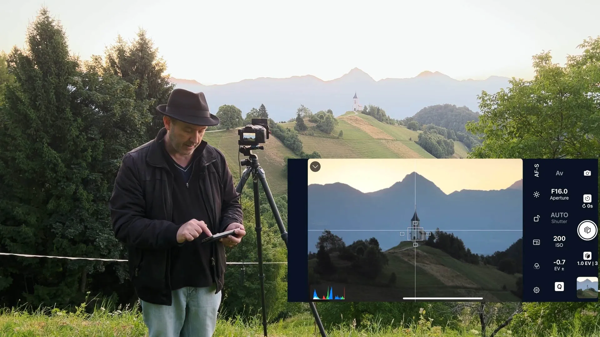Equipment used for capturing the sunrise over a mountain peak.